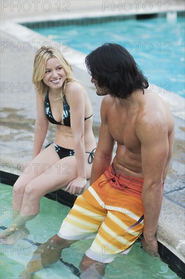 Caucasian couple relaxing in hot tub