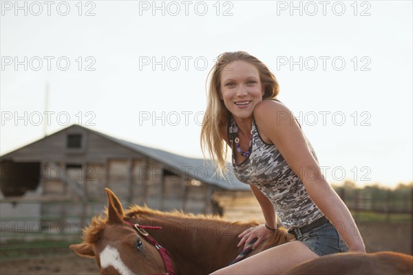 Caucasian girl sitting on horse