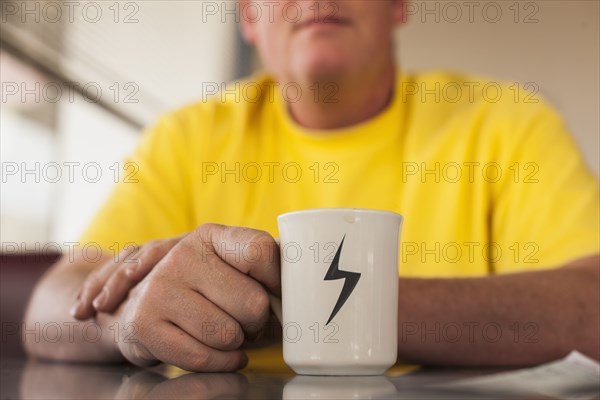 Close up of Caucasian man having cup of coffee