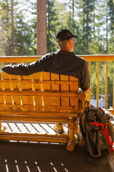 Caucasian man sitting on wooden bench