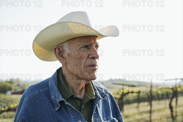 Hispanic farmer standing in vineyard