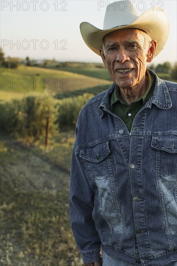 Hispanic farmer standing in vineyard