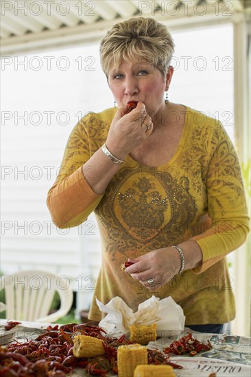 Caucasian woman eating at crawfish boil
