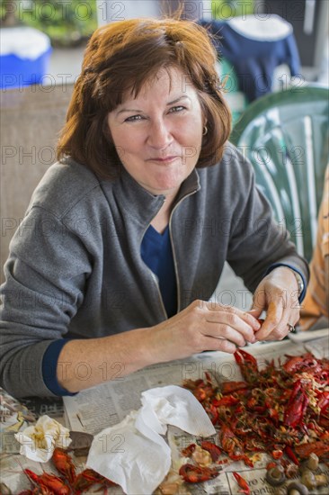 Caucasian woman eating crawfish at boil