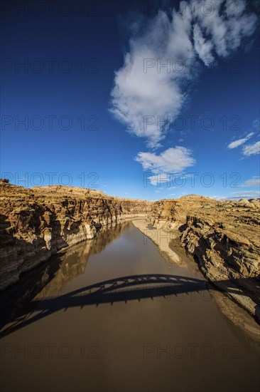 Shadow of bridge over lake in dry landscape