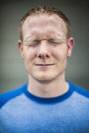 Close up of Caucasian man squinting