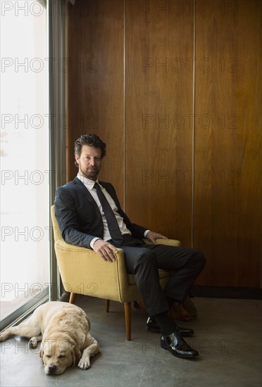 Caucasian businessman sitting in armchair