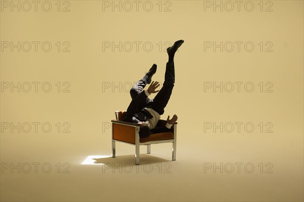 Caucasian businessman sitting under spotlight