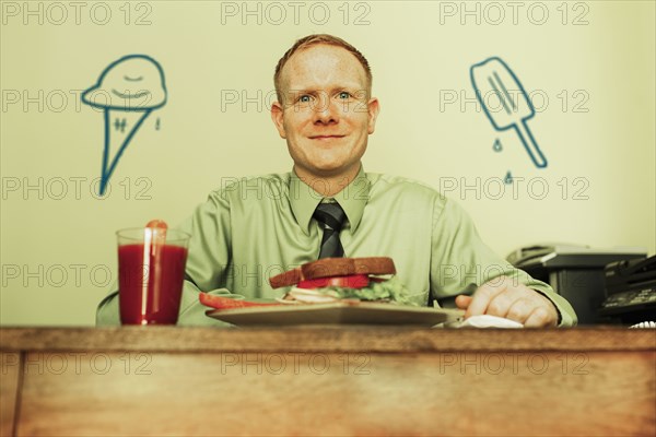 Caucasian businessman eating lunch