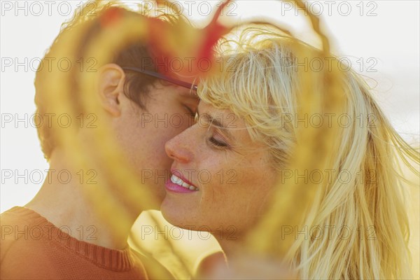 Caucasian couple holding woven heart