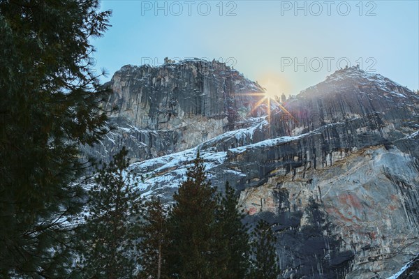 Sun rising over rocky landscape