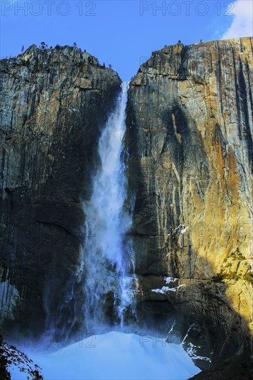 Waterfall over sheer rocky cliffs