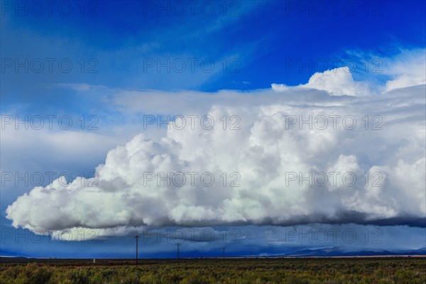 Storm clouds moving across rural prairie