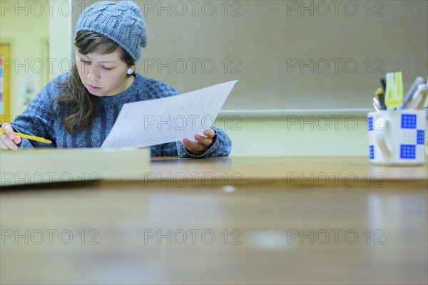 Hispanic student working in classroom