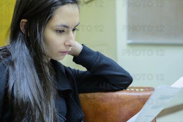 Middle Eastern student reading in classroom