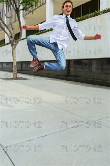 Hispanic businessman clicking his heels