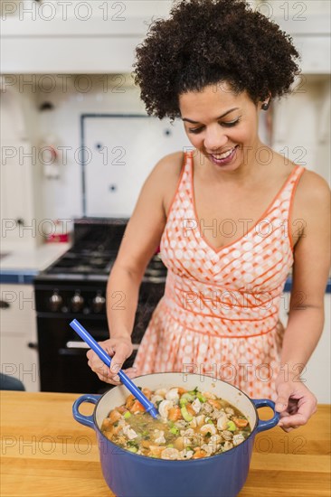 African American woman cooking in kitchen