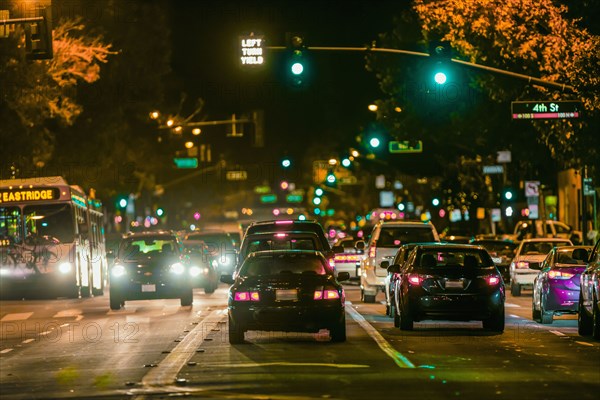 Cars driving in city traffic at night