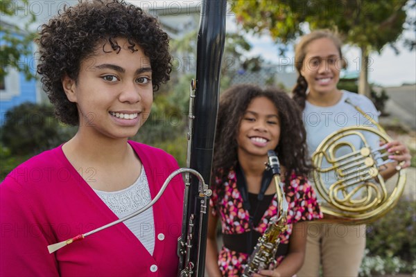 Pacific Islander girls holding musical instruments