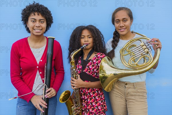 Pacific Islander girls holding musical instruments