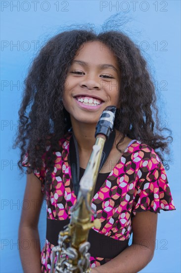 Pacific Islander girl holding saxophone