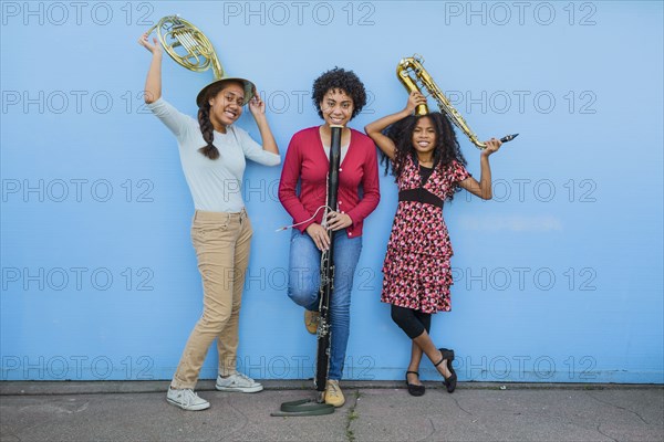 Pacific Islander girls holding musical instruments