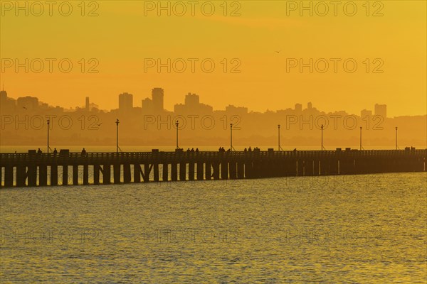 Silhouette of San Francisco city skyline over highway on bay