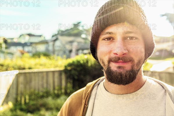 Caucasian man smiling in backyard