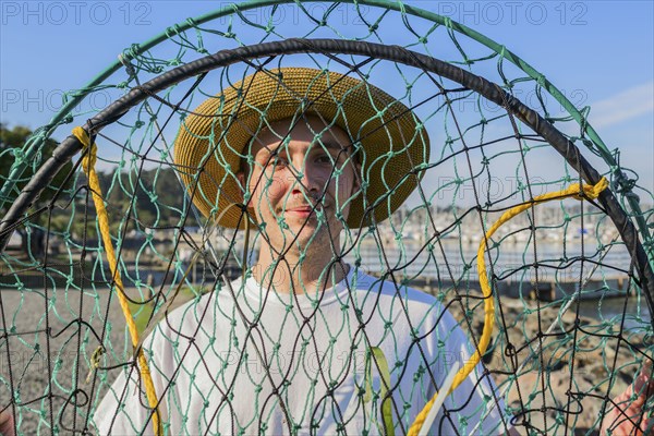 Caucasian man holding fishing net