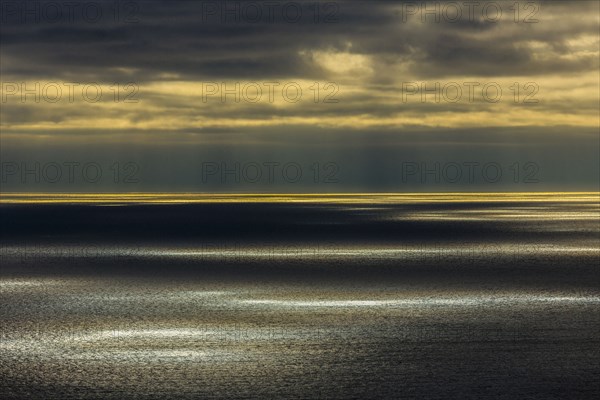 Sunbeams shining over ocean seascape