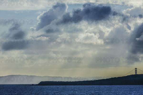 Sunbeams shining through clouds over ocean