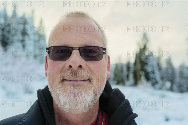 Caucasian man in snowy field