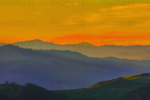 Silhouette of remote hills under sunset sky