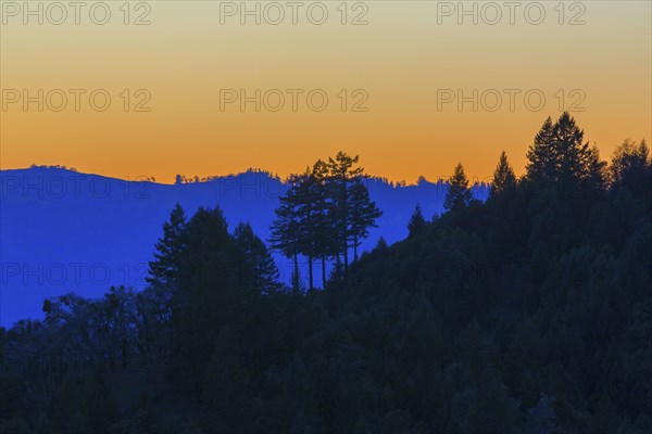 Silhouette of remote hills under sunset sky