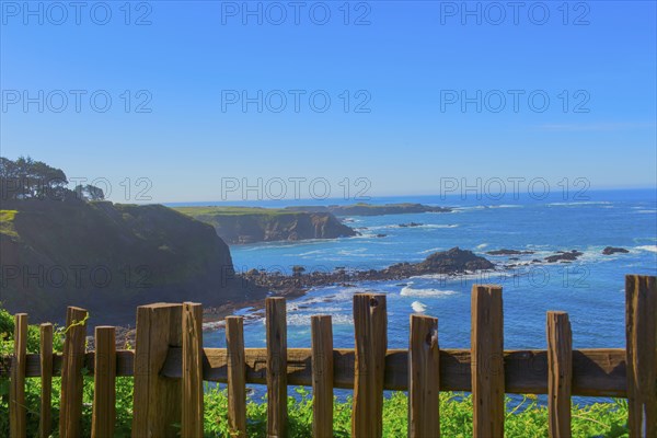 Wood fence overlooking rocky coastline