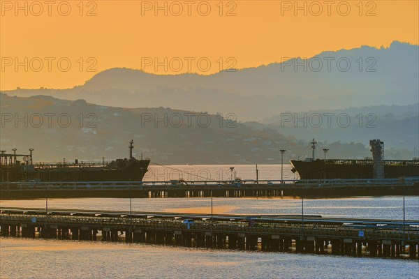 Silhouette of hills over industrial port harbor