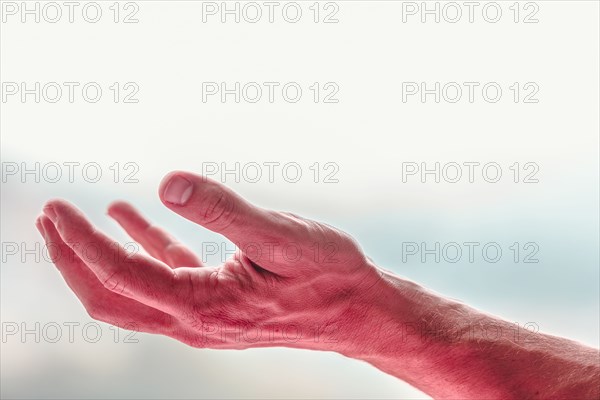 Close up of reaching hand of Caucasian man