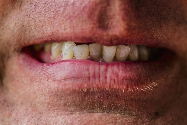 Close up of lips of Caucasian man grimacing