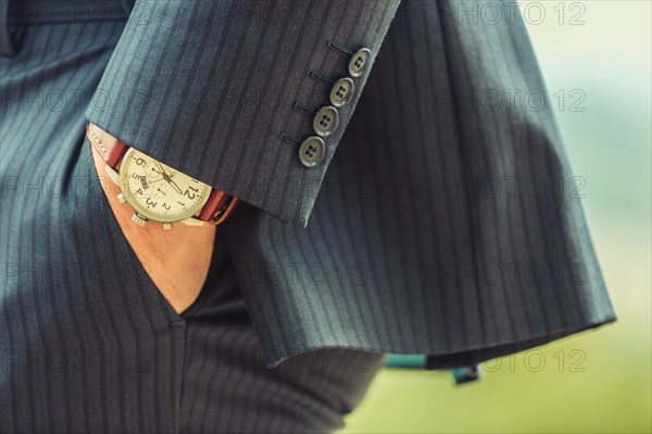 Close up of hand in pocket of Caucasian businessman