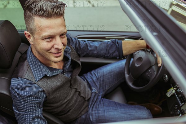 High angle view of Caucasian man driving car