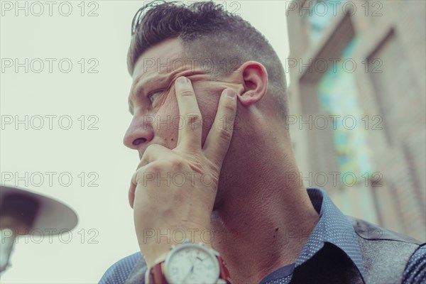 Caucasian businessman resting hand on chin