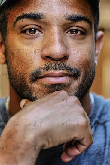 Close up of hand on chin of mixed race man