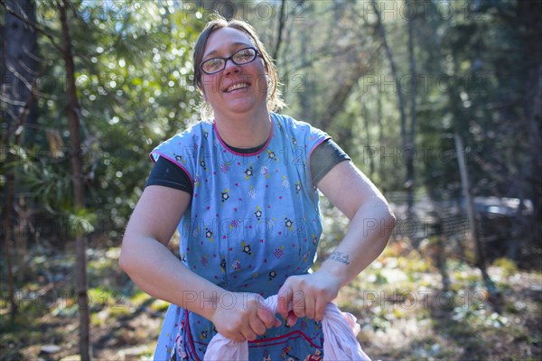 Caucasian woman washing clothes in forest