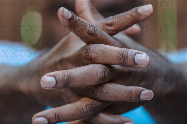 Close up of intertwined fingers of Black man