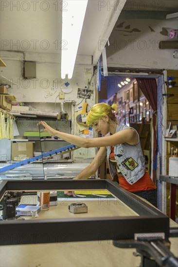 Caucasian artist working in screen print workshop