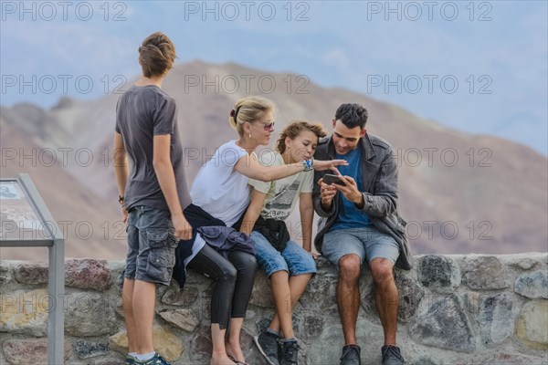 Family using cell phone at national park