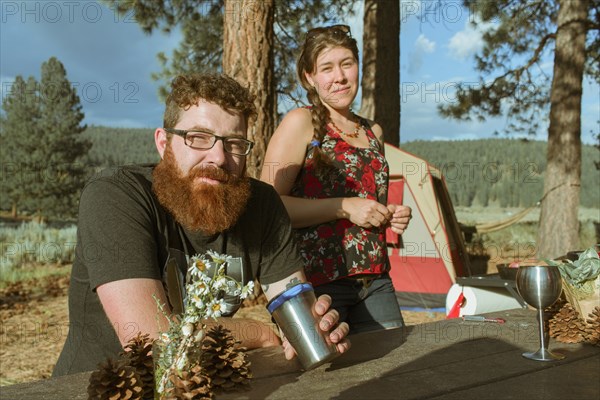 Caucasian couple relaxing at campsite