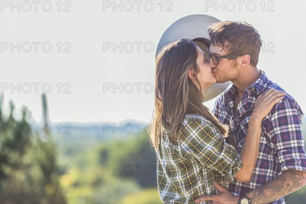 Caucasian couple kissing outdoors