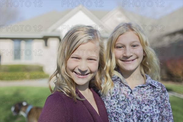 Caucasian girls smiling in yard