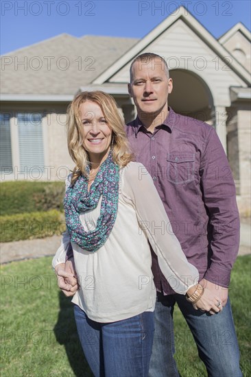 Caucasian couple hugging in yard